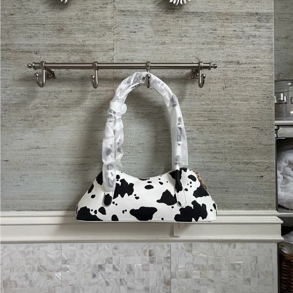 NWT new Anthropologie melie bianco east west shoulder bag cow print black white
